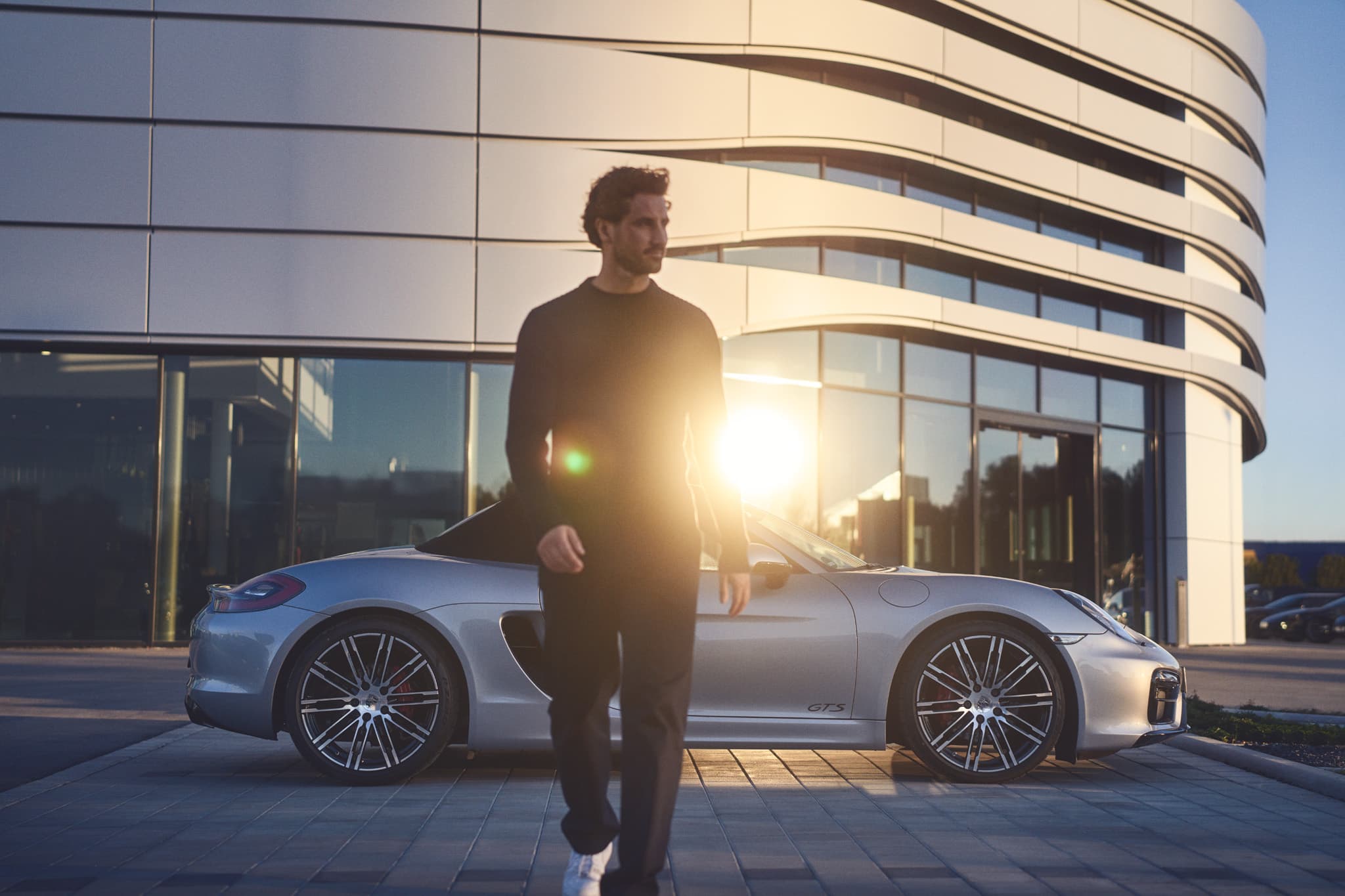 Person walking from a Porsche Center